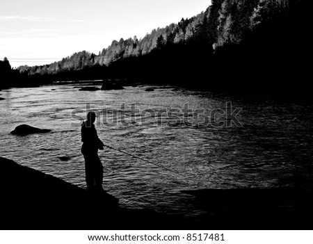 autumn fishing in a river just before sunset