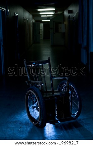 old wheelchair standing in a empty corridor