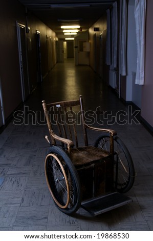 old wheelchair standing in a empty corridor