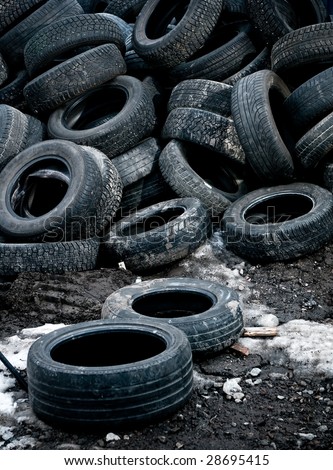 a large pile of used car tires waiting for recycling