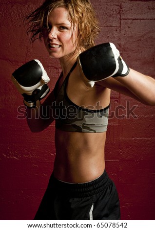 stock photo a young and fit female fighter posing in combat poses