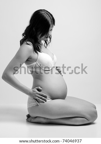 stock photo : a young pregnant brunette with her growing belly stock photo : a young pregnant brunette with her growing belly