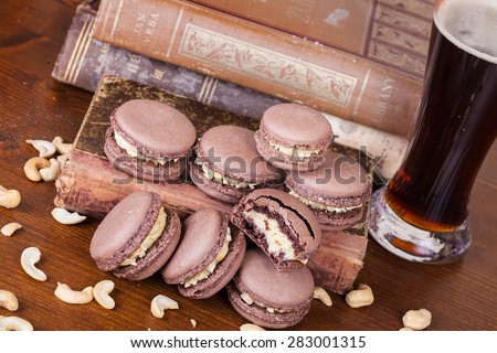 Traditional french macaroons with cashew nuts and old books