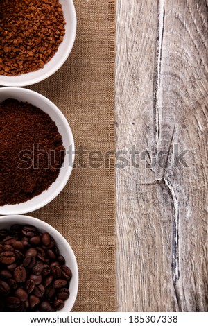Coffee beans, ground coffee and instant coffee in three bowls