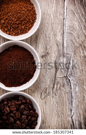 Coffee beans, ground coffee and instant coffee in three bowls