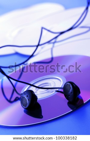 compact disk with earphone, on blue lighting