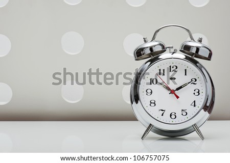 classical alarm clock on vintage background