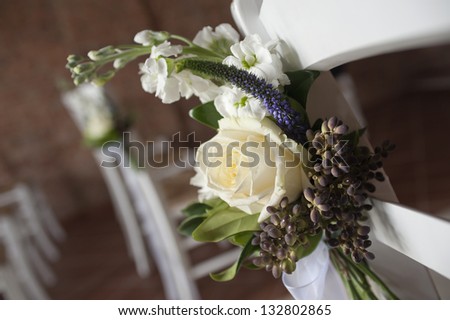 decorative flowers on chairs in church for wedding ceremony