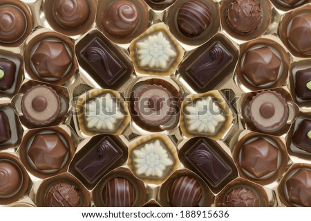 assorted chocolates confectionery in their gold box packaging