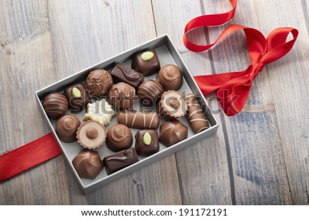 assorted chocolates confectionery in their gift box with red bow assorted chocolates confectionery in their gift box with red bow
