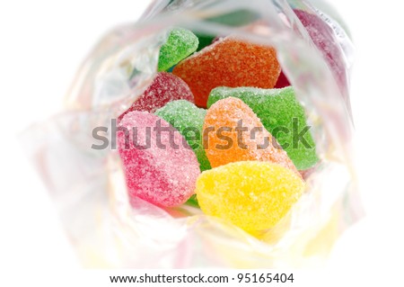 fruit jelly candies in transparent bag, on white background