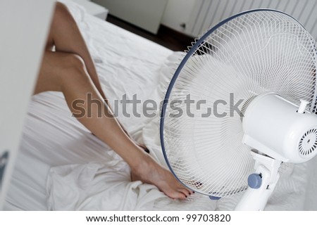 girl lying with fan running