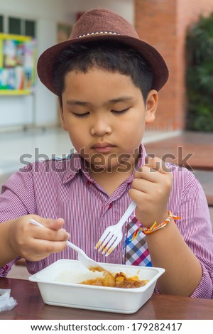 Cute boy enjoy eating food