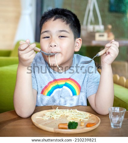 Cute Asian little boy enjoying food