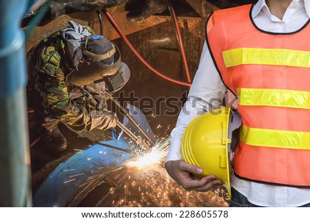 Engineer control Worker welding the pipe part at pipeline construction site