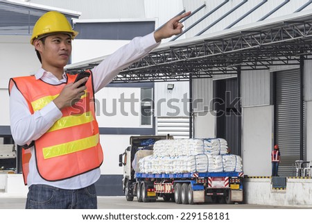 transportation engineer control truck loading product at warehouse building