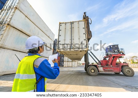 transportation engineer control forklift handling the reefer container box at dockyard