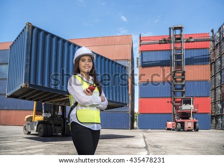 Conceptual image of logistics business, Engineer with Forklift truck lifting cargo container box in logistic industrial area