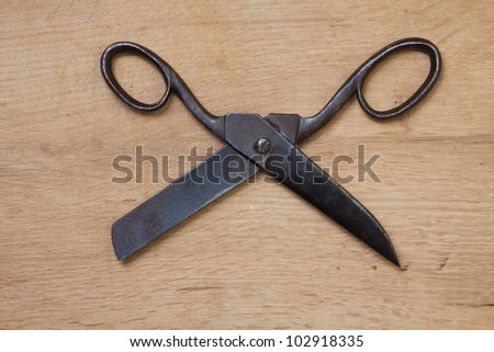 Old scissors on wood