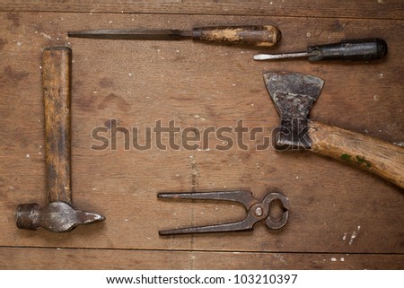 Vintage work tools on grunge wood