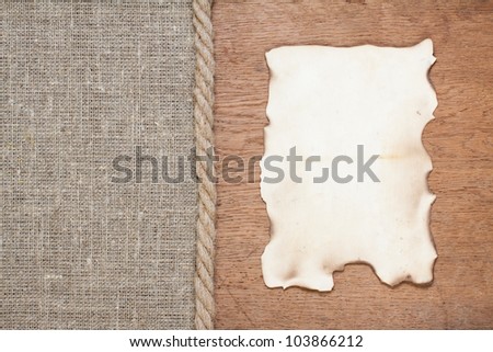 Old paper frame on oak wood and canvas with rope background