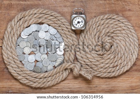 Rope frame, vintage clock, antique coins, on oak wood texture