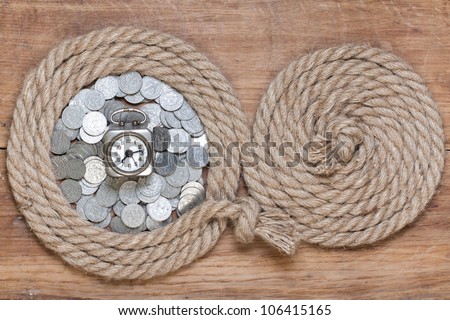 Rope frame, vintage clock, antique coins, on oak wood texture