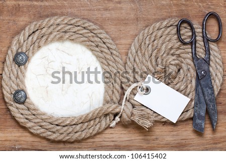 Old scissors, rope frame, price tag, buttons on wooden background