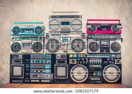 Retro old school design ghetto blaster stereo radio cassette tape recorders boombox tower from circa 1980s front concrete wall background. Vintage instagram style filtered photo