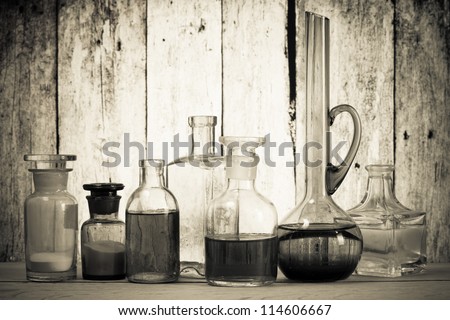Old laboratory glass in front of grunge wooden background