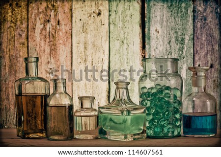 Old laboratory glass in front of grunge wooden background