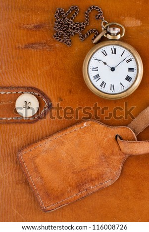 Vintage leather textured background with grunge label and antique pocket watch