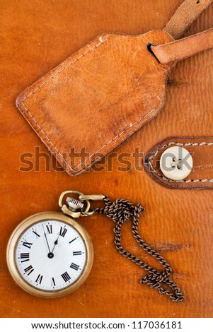 Vintage leather textured background with gift tag and antique pocket watch