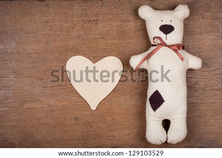 Handmade bear and love heart on wood