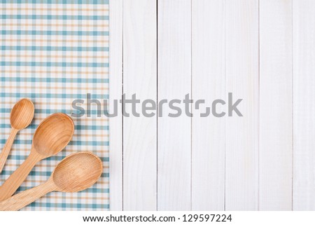 Tablecloth, kitchen equipment on white wood background