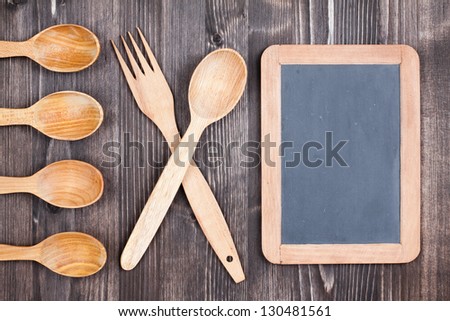 Menu black board, spoons, fork on wood background