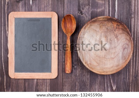 Blackboard for menu or recipe, wooden plate, spoon on wood texture background