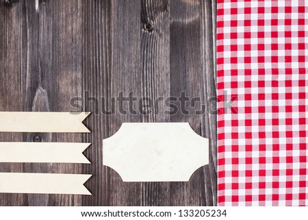 Tablecloth, paper labels on wood scrapbook cover background