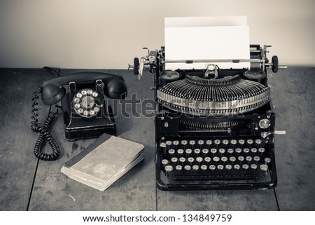 Vintage Typewriter, Telephone, Old Book On Table Desaturated Photo