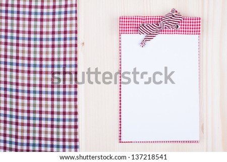 Recipe cook notebook, tablecloth on wood texture background