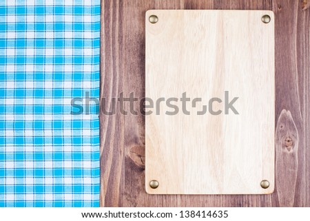 Wooden menu signboard, tablecloth on wooden background