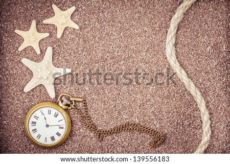 Vintage pocket watches on sand background