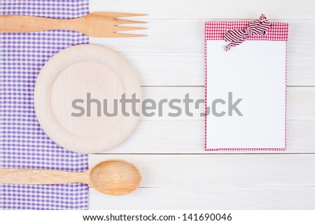 Recipe cook book, kitchen equipment on white wood background