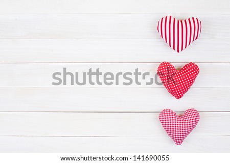 Love hearts hanging on vintage white wood background