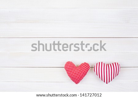 Hearts on white wood background