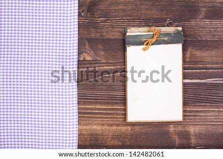 Recipe cook notebook, tablecloth on wood background