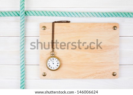 Signboard with vintage pocket watch, rope on white wood wall background
