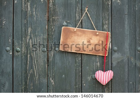 Valentine love heart, sign board hanging on wooden planks background