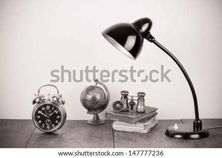 Retro table lamp, alarm clock, compass, binoculars, books