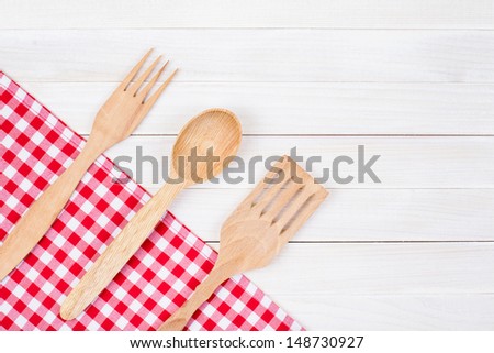 Tablecloth, kitchen equipment on white wood background
